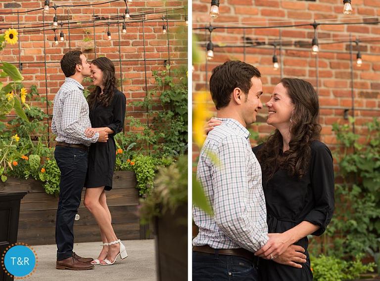 A couple kisses outside a historic brick building in Detroit