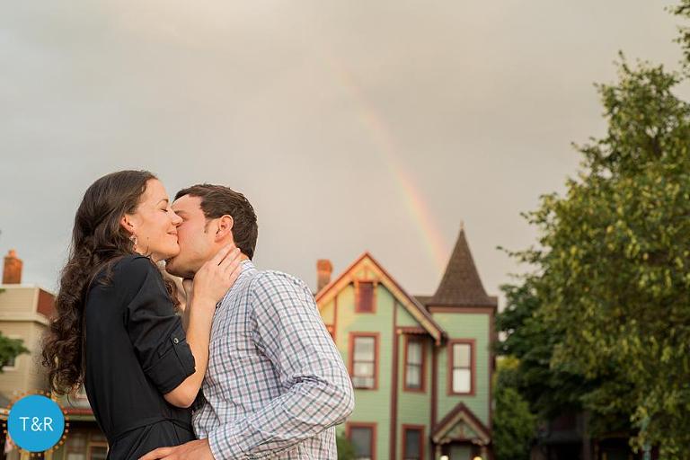 A couple kisses with a rainbow behind them in Corktown Detroit