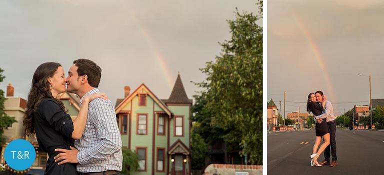A couple embraces with a rainbow behind them in Corktown Detroit during their engagement session