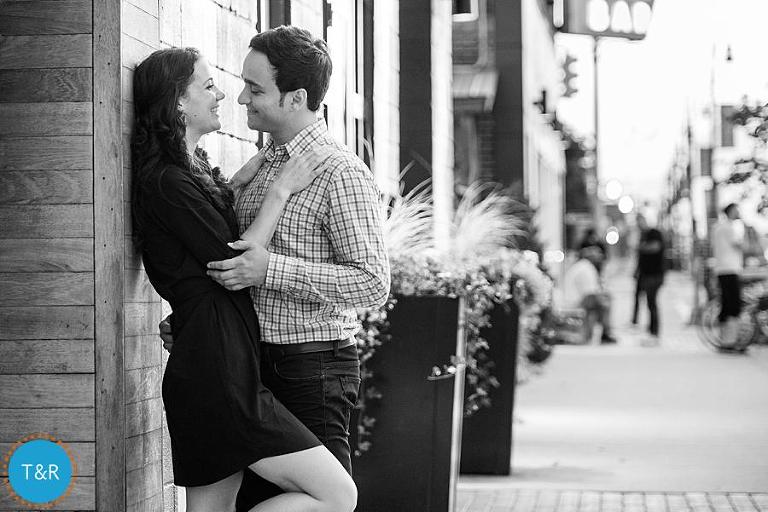 A couple embraces on the sidewalk in Corktown